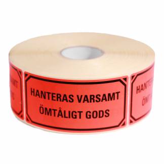 Advarselsetiketter Hanteras Varsamt Fluorescerende selvklæbende etiket med sort trykt text. Format 100x50mm, 1000 etiketter pr. rulle.